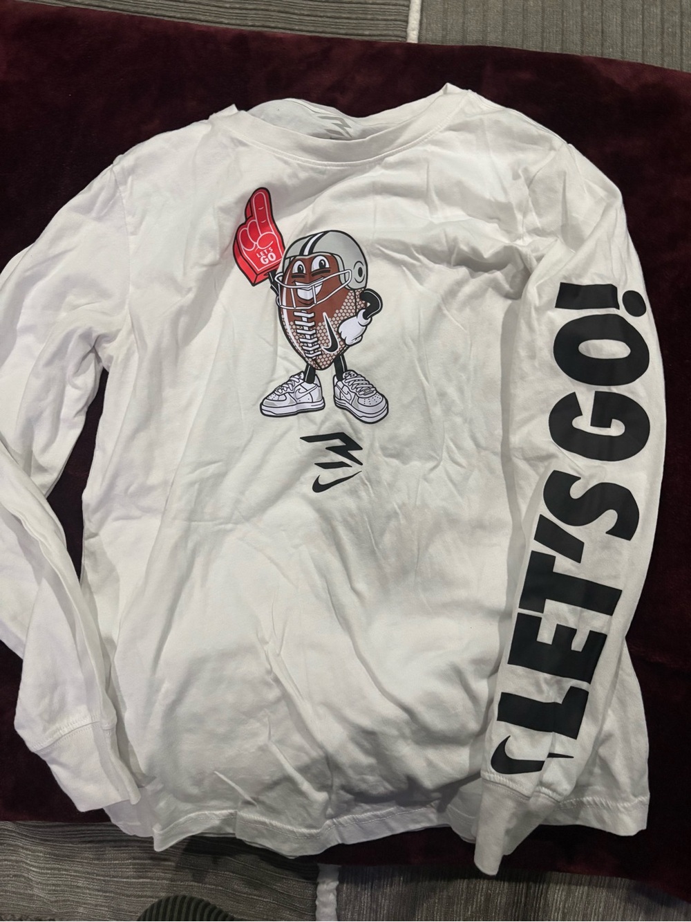 Nike White Long Sleeve Kids Tee with Football Character & Black Sleeve Text